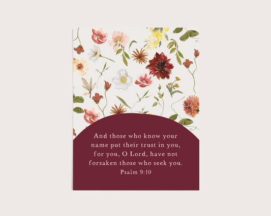 A vertical floral card or print with a white background decorated with watercolor-style flowers in pink, red, yellow, and green, plus a dark burgundy lower section containing a Bible verse from Psalm 9:10.