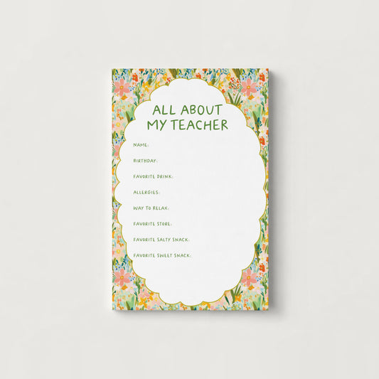 A rectangular printed cardwith a floral border and the title 'ALL ABOUT MY TEACHER' in green text, shown centered on a light gray background.